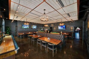 A restaurant with booths, tables, and a bar area.