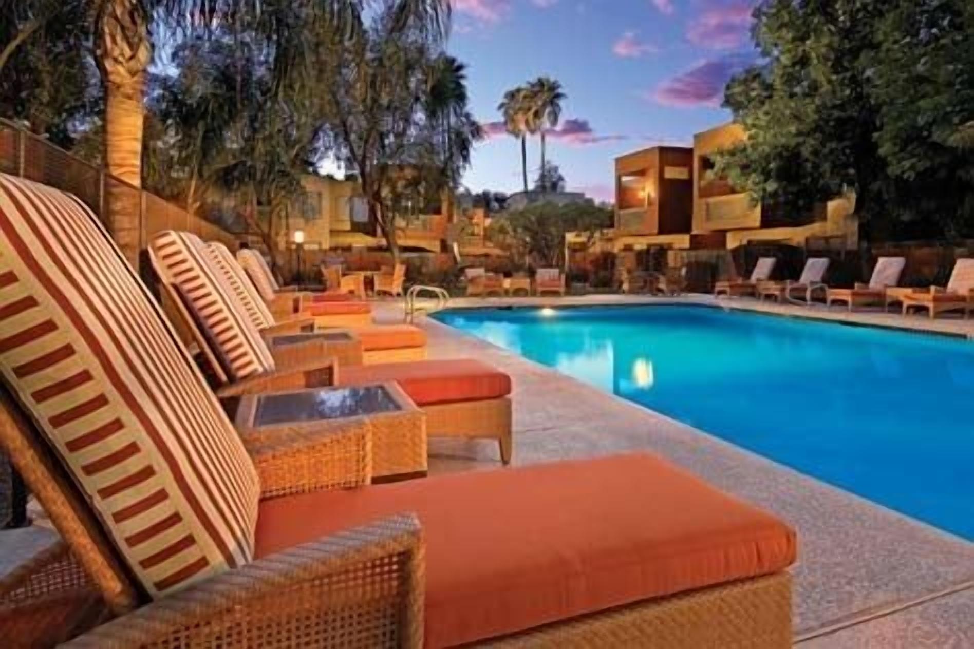 A poolside area with lounge chairs and a swimming pool.