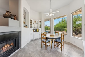 Enjoy family meals and gatherings in this kitchen with a fireplace and dining area.