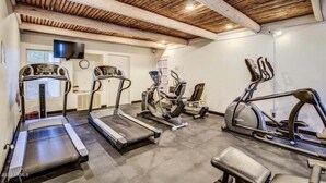 A home gym with treadmills, elliptical machines, and a bench. - Harmony Haven! Your Artful Escape (Scottsdale)
