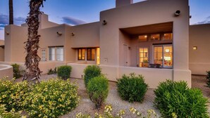 A modern building with a flat roof, multiple windows, and a well-maintained garden with various plants and flowers. - Harmony Haven! Your Artful Escape (Scottsdale)