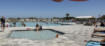 Peek of the ocean King size bed just Steps from the Beach