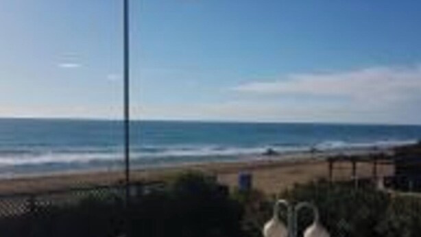 A view of the beach with a fence and a clear sky. - Lovely  Sea view Apartment in Gava (Gava)