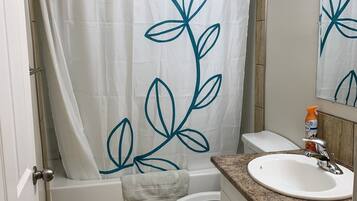 Combined shower/tub, towels, soap, shampoo