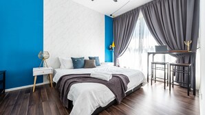 A modern bedroom with a bed, bedside tables, a desk, and a ceiling fan. - 3BR Homestay with Pool View Bukit Rimau (Shah Alam)