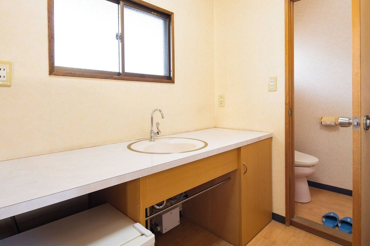 A bathroom with a sink, mirror, and toilet.