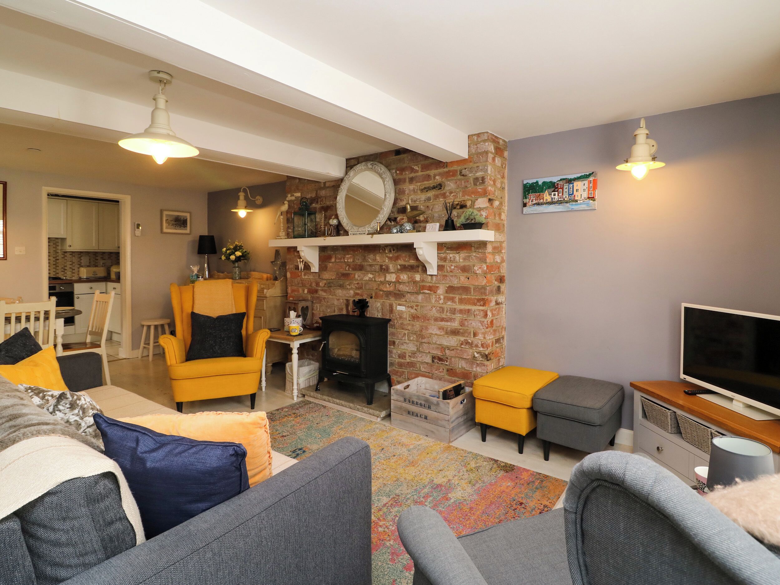 A cozy living room with a fireplace, a television, and comfortable seating.