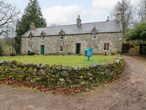 A stone cottage with a sign indicating it is part of North Malts Cottages. - North Mains Cottage - Craigievar Castle (Alford)