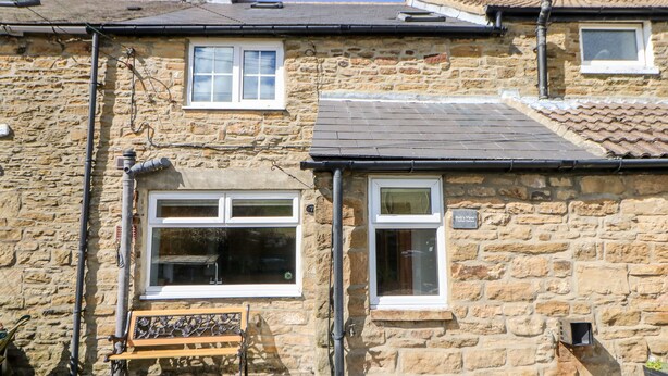 A stone house with a bench outside, a small window, and a sign reading "Bolt's View". - Bolt's View (Bishop Auckland)