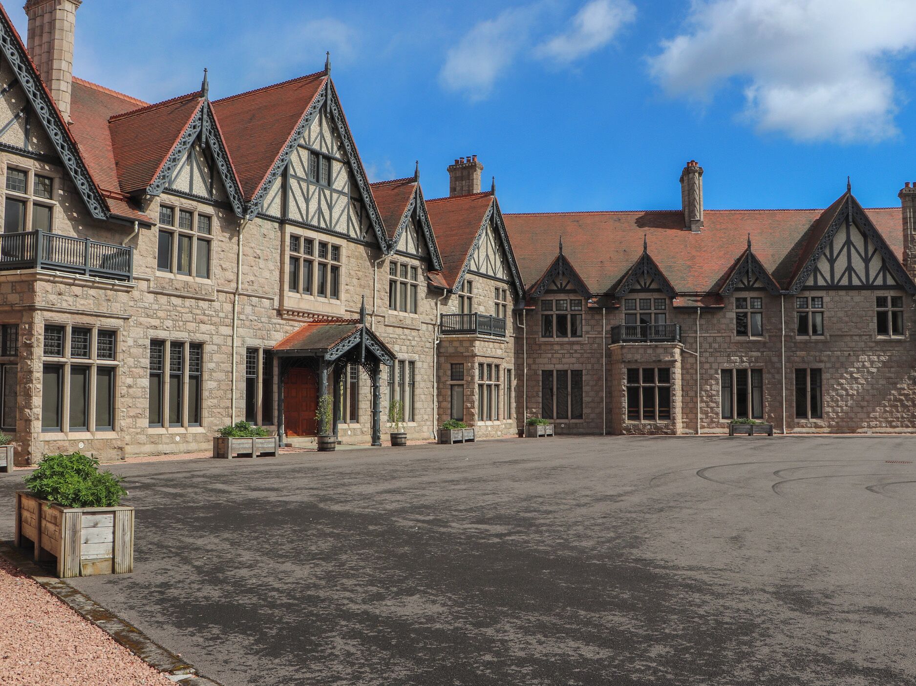 A historic building with multiple gabled roofs and stone walls.