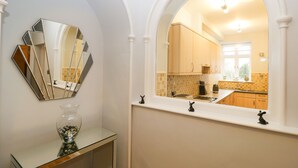 A bathroom with a mirror, a glass vase, and a sink. - Tethera (Windermere)