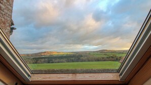 A skylight with a view of a green landscape and hills. - Windy Mundy Farm at Pitchford Estate (Shrewsbury)