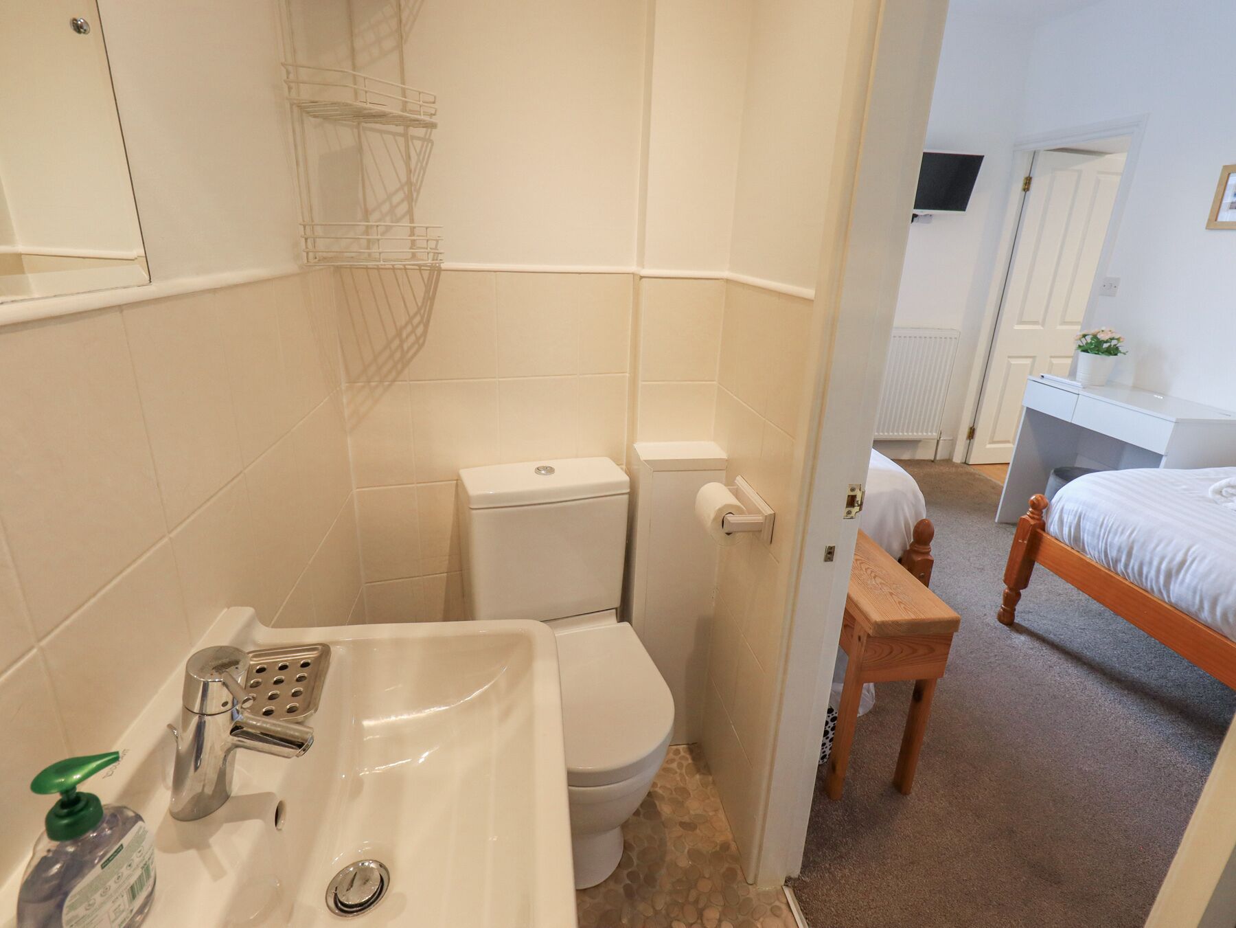 A bathroom with a sink, toilet, and shower area.