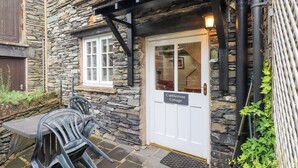A stone cottage with a sign reading "Cobblestone Cottage." - Cobblestone Cottage (Ambleside)