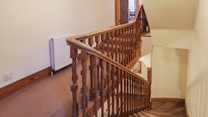 A wooden staircase with a handrail, leading to an upper floor. - Kinnaird House (Grantown-on-Spey)