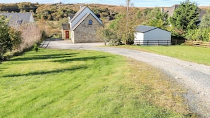 A rural property with a stone house, a gravel driveway, and a fenced yard. - Crolly Home (Crolly)