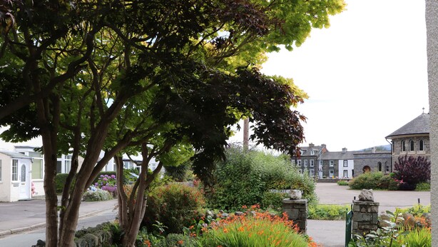 A garden pathway leading to a stone building with a sign reading "Ash Tree." - Fell View (Keswick)