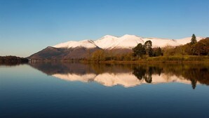 A tranquil lake with a mountain range in the background. - Grange Fell (Keswick)