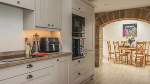 A kitchen with a built-in oven, microwave, and coffee maker. - Shepherd's Crook (Harrogate)