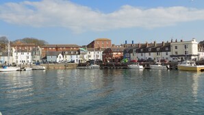 A harbor with boats, a variety of buildings, and a clear sky.