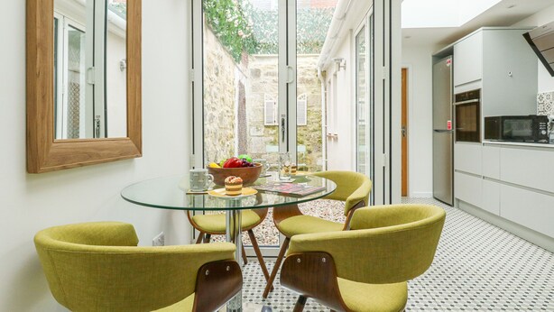 A modern kitchen with a dining area.