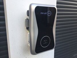 A PROJECT EV electric vehicle charging station with a sleek design, a digital display, and an EV ChargePoint symbol.