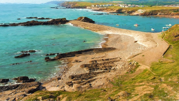 A coastal landscape with rocky shores, clear waters, and boats. - Silver Crooks (Holsworthy)