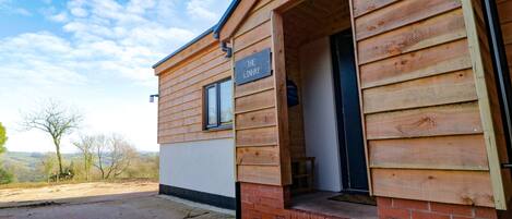 A wooden cabin with a sign reading "THE LINHAV".
