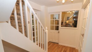 A staircase with white railings leading to a landing with a glass door. - Yr Hen Ysgol, The Old School (Porthmadog)