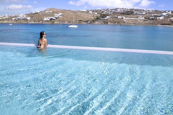 Una piscina al aire libre de temporada, sombrillas