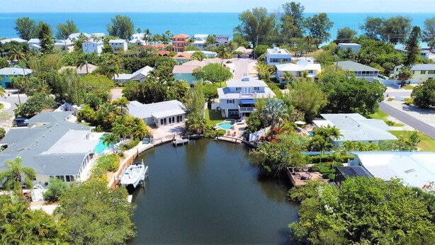 Zona residencial com casas, um canal e vista para o oceano.