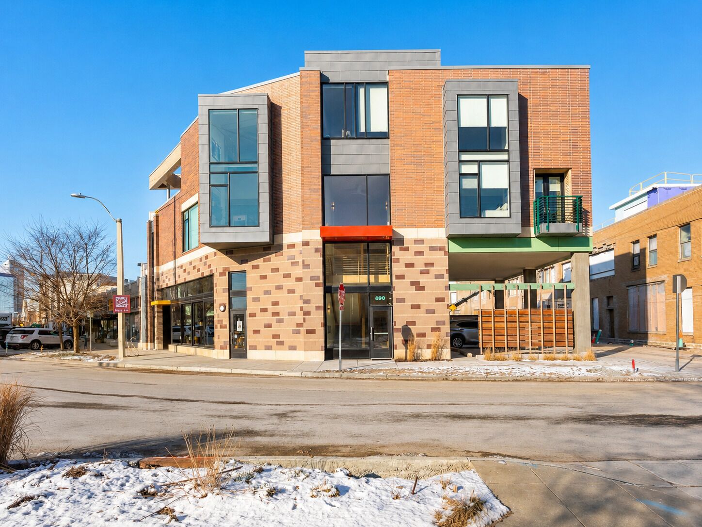 A modern multi-story building with large windows and a flat roof.