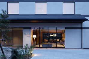 A modern hotel entrance with large glass doors, a well-lit interior, and a visible seating area. - Fairfield by Marriott Wakayama Kushimoto (Kushimoto)