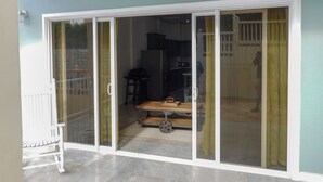 A room with a sliding glass door leading to a balcony. - The Best of Home - Tranquil, Comfort & Convenient (Beausejour)