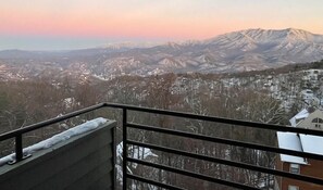 A balcony with a view of a mountainous landscape during sunset. - Extraordinary Mountain Views/Indoor Pool & Hot Tub (Gatlinburg)