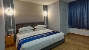 A modern hotel room with a large bed, two bedside tables, and a nightstand. - Good 9 Hotel, Cahaya Kota Puteri (Masai)