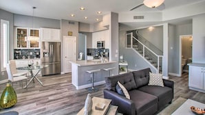 A modern kitchen with stainless steel appliances, a glass dining table, and a bar area. - On Golf Course! Snowbird Resort Retreat in Mesa (Mesa)
