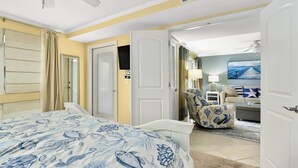 A hotel room with a bed, a chair, a desk, and a painting on the wall. - 2 BR 2 BA Unit with Beautiful Bay Views (Ocean City)