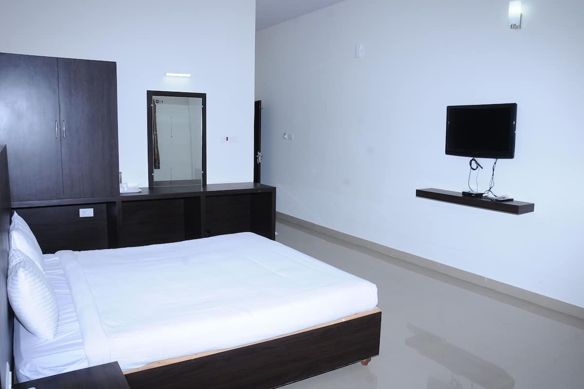 Habitación Deluxe | Ropa de cama de alta calidad y tabla de planchar con plancha