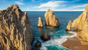 A coastal landscape with large rock formations and a sandy beach. - Astonishing Studio at Cabo San Lucas (Cabo San Lucas)