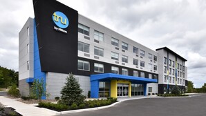 A modern hotel building with a prominent 'tru by Hilton' sign, multiple floors, and a covered entrance area. - Tru by Hilton Beckley (Beckley)