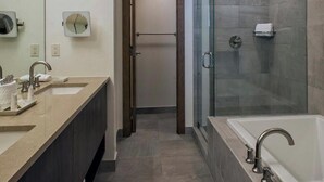 A modern bathroom with a large mirror, two sinks, a shower, and a bathtub. - Grand Colorado Peak 8 (Breckenridge)