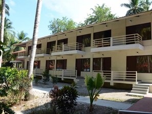 A multi-story building with balconies and a garden area. - Coconhuts Beach Resort-neil Island (Port Blair)
