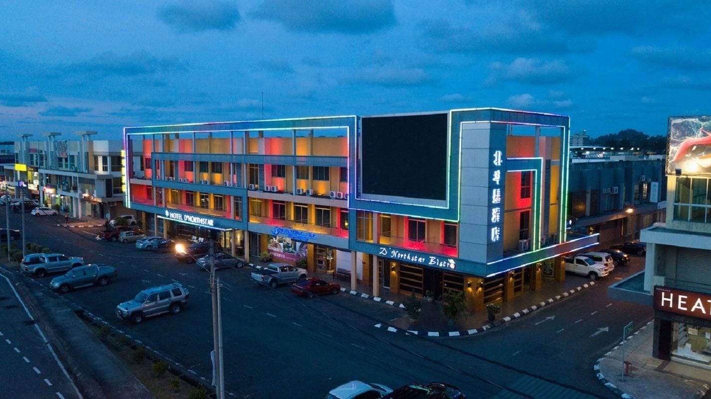 A multi-story hotel with a modern design, featuring a prominent entrance and a visible restaurant sign.