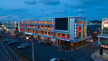 A multi-story hotel with a modern design, featuring a prominent entrance and a visible restaurant sign.