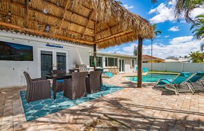 Relax by the pool and enjoy meals on the shaded patio with a dining table and comfortable seating.