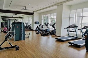 A gym with treadmills, elliptical machines, and weightlifting equipment.