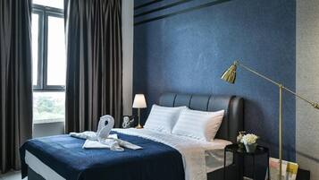 A hotel room with a large bed, a nightstand, a lamp, and a view of the outdoors through a window.