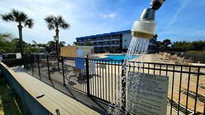 Relax by the resort pool surrounded by lounge chairs and a deck, with a clear view of the pool.