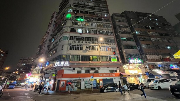 A multi-story hotel with a ground-level restaurant and a visible sign for 'Mannings'. - Garden Hotel (Kowloon)